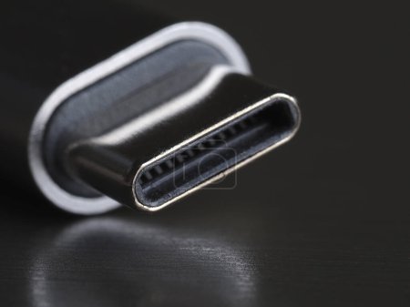 USB Type-C cable on a dark background, close-up, selective focus