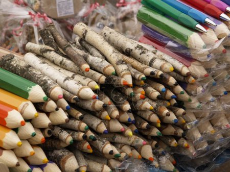 Collected sets of sharpened colored wooden pencils handmade on a market counter