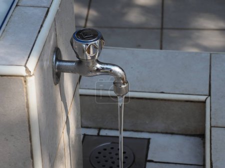 An open tap with water in the city pump house