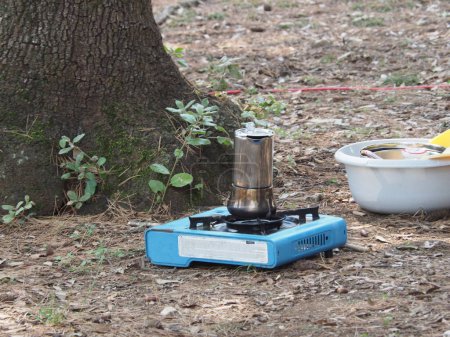 Making coffee in a geyser coffee maker at the campsite