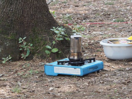 Making coffee in a geyser coffee maker at the campsite