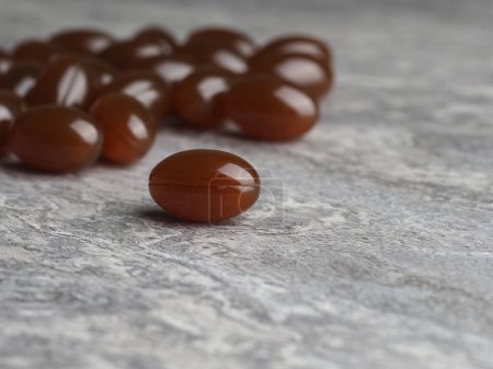 A group of lecithin capsules on a textured gray background