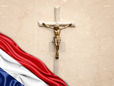 Foto de Bandera de los Países Bajos de seda con Jesucristo, estatua, cruz, apoyada sobre fondo de mármol - Imagen libre de derechos