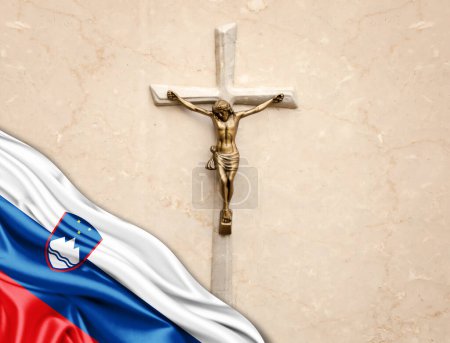 Foto de Bandera de Eslovenia de seda con Jesucristo, estatua, cruz, apoyada sobre fondo de mármol - Imagen libre de derechos