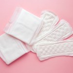 Different types of female pads during the menstrual cycle on a pink background. Feminine hygiene products during menstruation