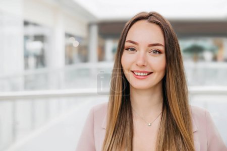 Photo for Close up portrait of a young caucasian brunette woman in a beige business suit. copy space - Royalty Free Image