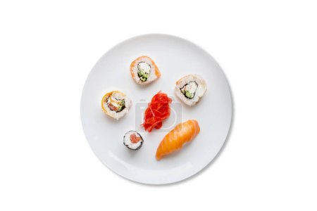 Different types of sushi rolls on white plates isolated on white background top view