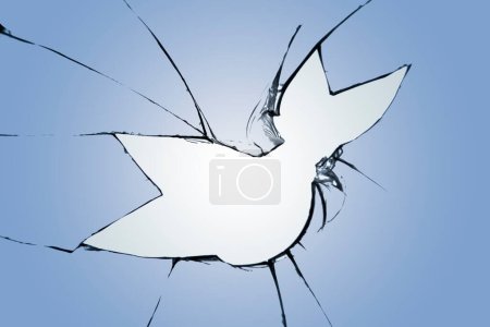 Photo for Broken blue glass with a hole and space for text in the center with a white background. - Royalty Free Image