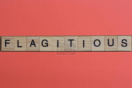 Photo for Text the word flagitious from gray wooden small letters with black font on an red table - Royalty Free Image