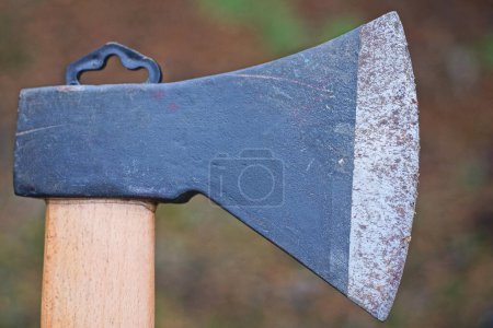 Photo for Part of one old big gray black iron ax with a sharp blade on the street - Royalty Free Image