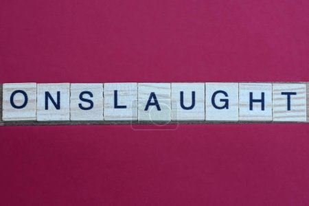 gray word onslaught from small wooden letters on a red table