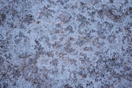 natural texture of frozen gray white gray ice on the street