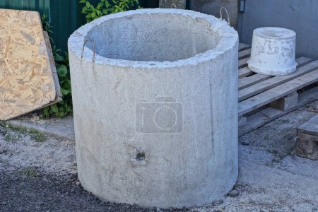 one large gray concrete ring stands on the ground on the street