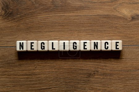 Negligence - word concept on building blocks, text, letters