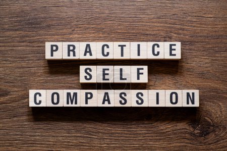 Practice self compassion - word concept on building blocks, text, letters