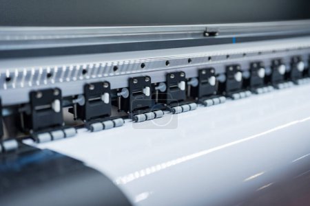 Close-up of large format printer heads in action, Detailed view of modern large format printer heads working on white media