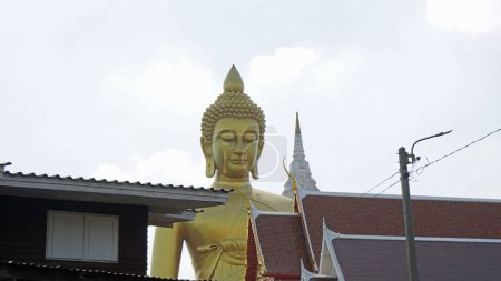 golden buddha statue at chao praya river in bangkok