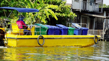 garbage disposal boat on a river in bangkok in thailand