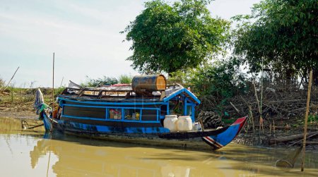 traditional wooden boat on the tonle sap river in cambodia