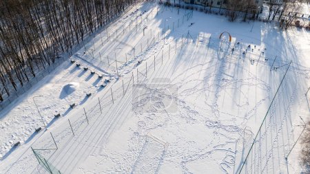 Drohnenaufnahmen von Fußball-, Basketball- und Volleyballfeldern, die an sonnigen Wintertagen mit Schnee bedeckt sind