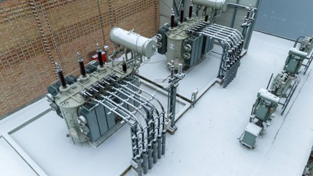Drone photography of electrical sub station covered by snow during winter cloudy day