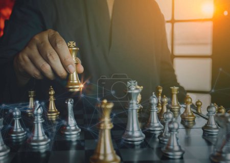 Photo for Hand of businessman holding gold king chess on stock market or forex trading graph chart with cityscape image economy trend for digital financial investment.Management or leadership strategy concept. - Royalty Free Image