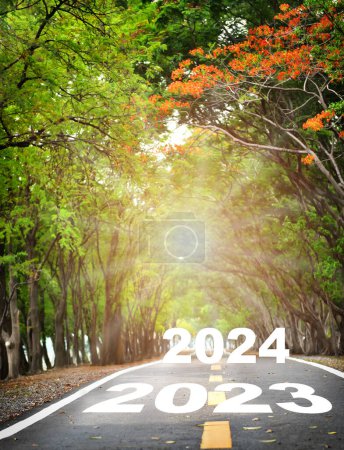 Photo for New year 2023 to 2024 with white arrow sign marking on road surface. Business opportunity concept and challenge idea - Royalty Free Image