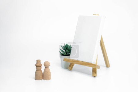 Photo for Wooden doll with empty easel on white background; business or creative concept - Royalty Free Image