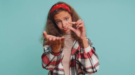 Photo for Need some more, please give me. Teenager child girl kid 12 years old showing a little bit gesture with sceptic smile, showing minimum sign, measuring small size. Preteen children on blue background - Royalty Free Image