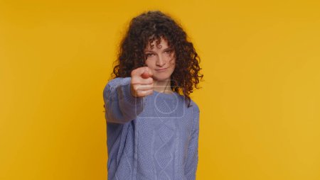 Photo for Angry aggressive young woman showing fig negative gesture, you dont get it anyway. Rapacious, avaricious, acquisitive. Body language. Refusal fig sign. Greedy avaricious girl on yellow background - Royalty Free Image