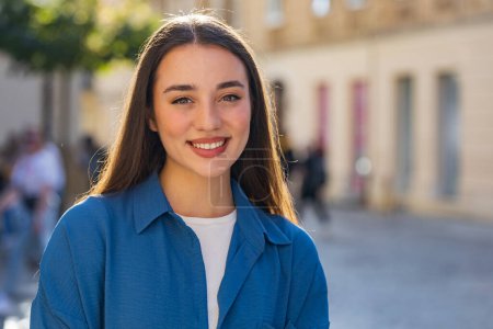 Photo for Close-up portrait of happy young woman face smiling friendly, glad expression looking at camera dreaming, resting, relaxation feel satisfied good news outdoors. Pretty girl in urban city sunny street - Royalty Free Image