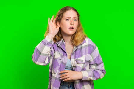 I cant hear you. What. Young woman trying hear you, looking confused and frowning, keeping arm near ear for louder voice, asking to repeat, to hear information, deafness. Girl on chroma key background