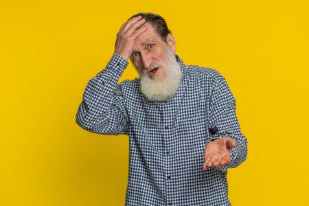 Sad senior old man feeling hopelessness loneliness, nervous breakdown, loses becoming surprised by lottery results, bad fortune, loss unlucky news. Mature grandfather isolated on yellow background