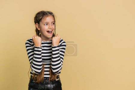 Young preteen child girl kid feeling hopelessness and loneliness, nervous breakdown, loses becoming surprised by game fail, bad fortune, loss, unlucky news. Teenager children on beige background