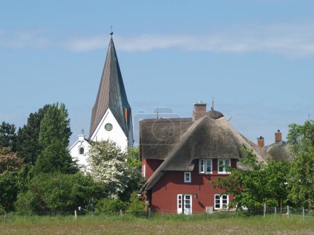 church and house in nebel, on the island amrum