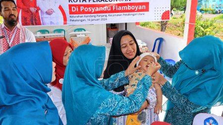Téléchargez les photos : Des élèves du primaire reçoivent des gouttelettes de vaccin antipoliomyélitique pour prévenir une épidémie plus importante Pekalongan Indonésie 16 janvier 2024 - en image libre de droit