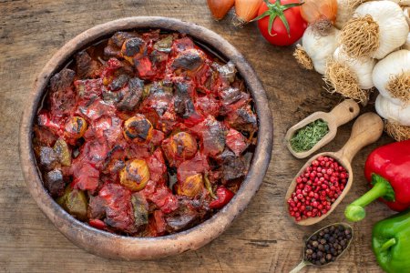 Casserole kebab named belen tava or sac kebabi . Roasted meat with pepper and tomato. 