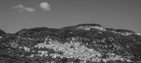 Photo for Pesche, village in the province of Isernia, in Molise, perched along the steep slopes of Mount San Marco, a white spot against the green of the mountain and the gray of the stones. - Royalty Free Image