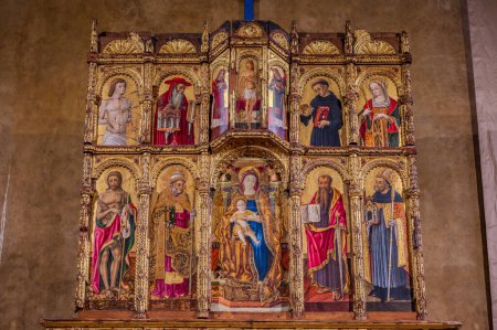 Photo for Church of Sant'Agostino. the Polyptych by Vittore Crivelli. The building is entirely made of brick and has two entrances. The interior has a single room, covered by wooden trusses. - Royalty Free Image