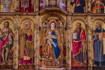 Photo for Church of Sant'Agostino. the Polyptych by Vittore Crivelli. The building is entirely made of brick and has two entrances. The interior has a single room, covered by wooden trusses. - Royalty Free Image