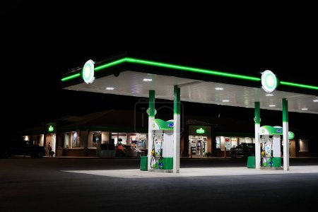 Photo for BP British Petroleum fuel station glows during the night outside of Fond du Lac, Wisconsin - Royalty Free Image