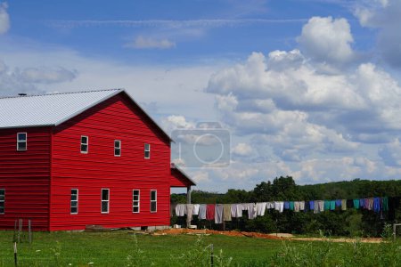 Photo for Red and blue wooden barn on a farm in south carolina - Royalty Free Image