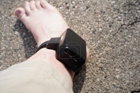Photo for House arrest GPS jail monitoring bracelet on male ankle due to jail sentence. - Royalty Free Image