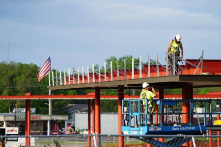 Foto de Mauston, Wisconsin, EE.UU. - 25 de mayo de 2021: Hombres en una obra de construcción construyendo una nueva estación de combustible durante el verano. - Imagen libre de derechos