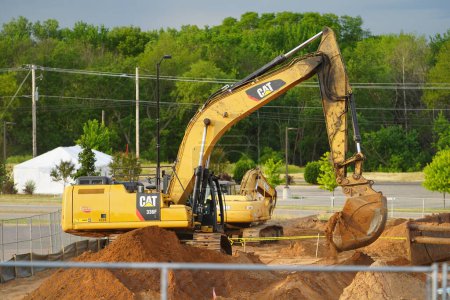 Photo for Mauston, Wisconsin USA - June 18th, 2021: CAT caterpillar excavator being used to do some construction in Mauston. - Royalty Free Image