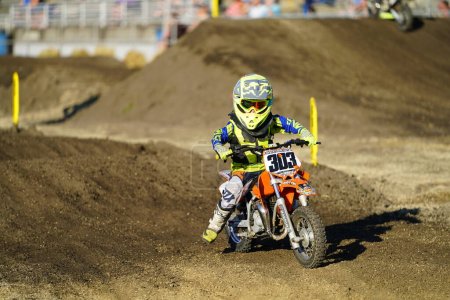 Photo for Dirt bikes raced and performed stunts during a Supercross motorsport race event on track. - Royalty Free Image