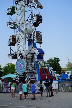 Photo for Families from the community came out during the day to enjoy themselves on amusement rides at a local amusement county fair. - Royalty Free Image