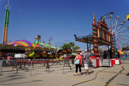 Photo for Families from the community came out during the day to enjoy themselves on amusement rides at a local amusement county fair. - Royalty Free Image