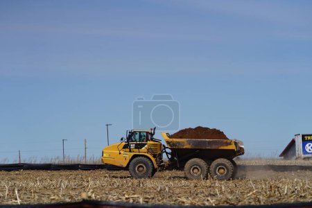 Photo for Mauston, Wisconsin USA - April 11th, 2022: 735 Articulated haul truck being used to move dirt and mud around. - Royalty Free Image