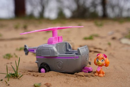 Photo for New Lisbon, Wisconsin USA - April 27th, 2022: Paw Patrol character Skye miniature toy and helicopter sitting outdoors. - Royalty Free Image